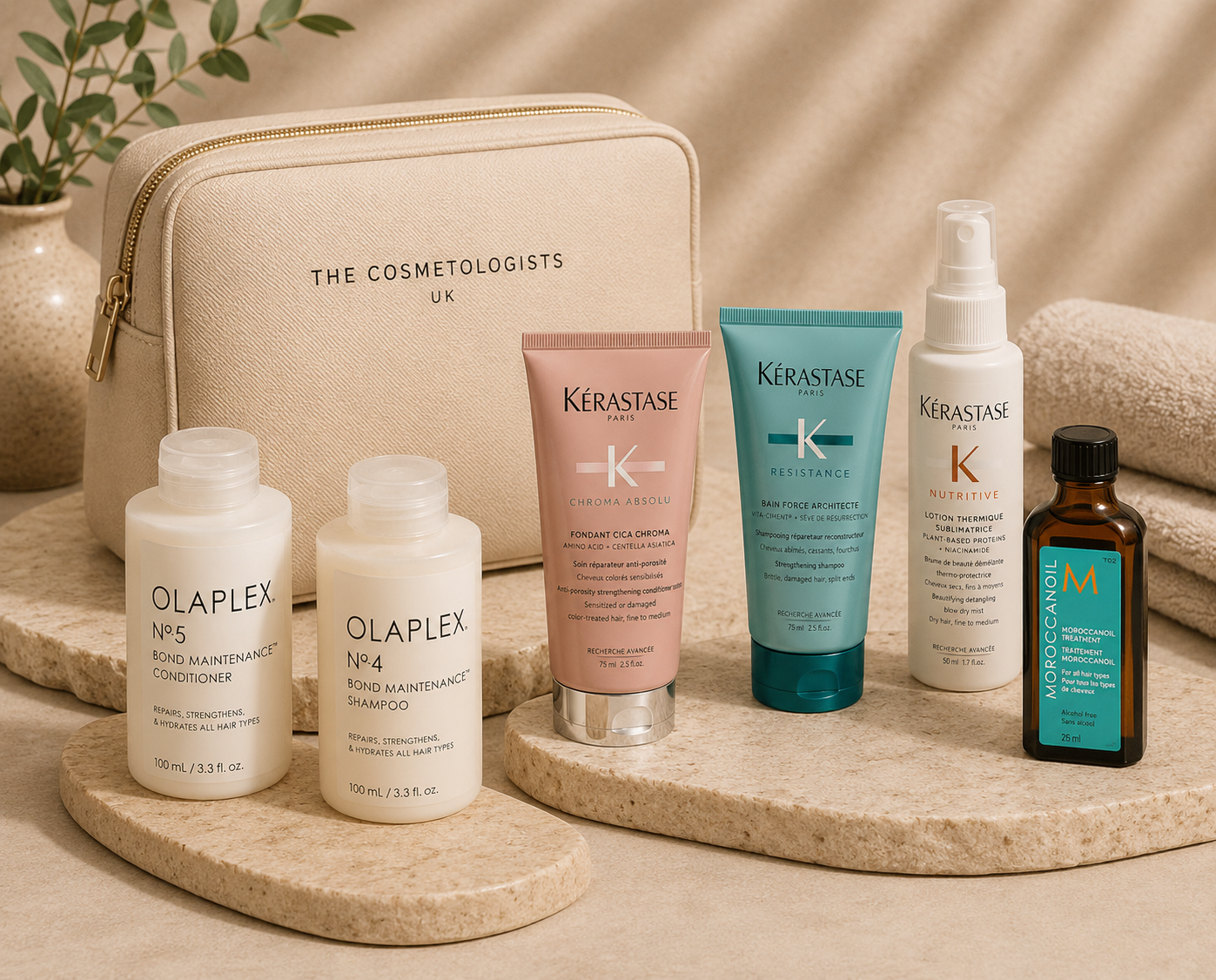 Luxury travel-size conditioners and mini haircare products including Olaplex, Kérastase and Moroccanoil essentials displayed beside a premium cosmetic travel bag on elegant beige stone surfaces in a sophisticated salon-inspired setting.