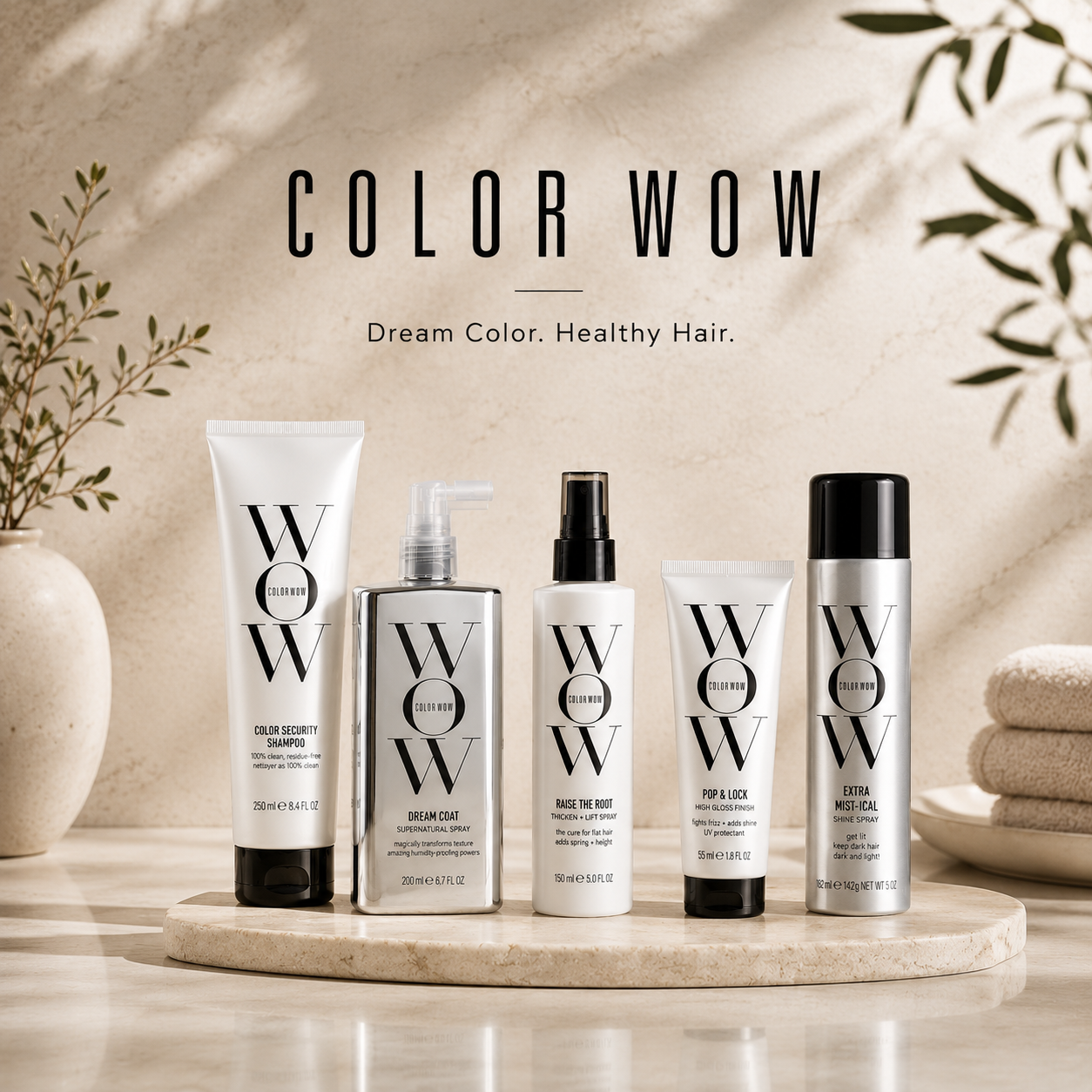 Color Wow hair care products on a marble surface with a neutral background