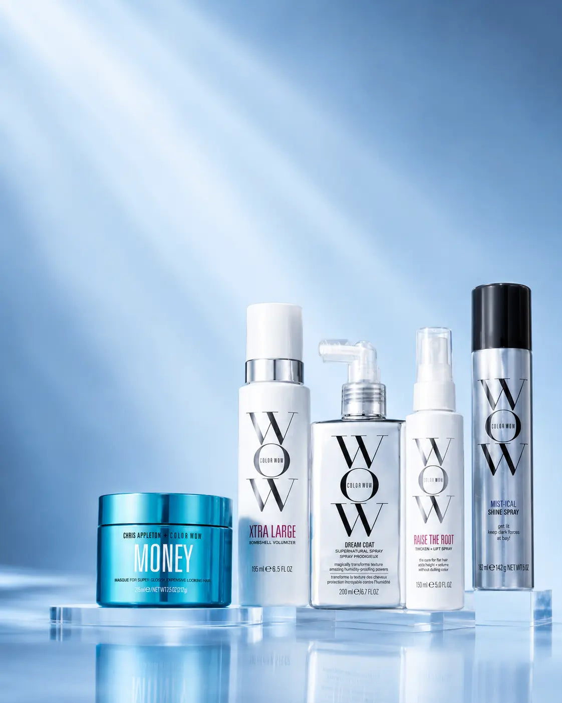 Collection of Color Wow hair care products on a reflective surface with a blue gradient background