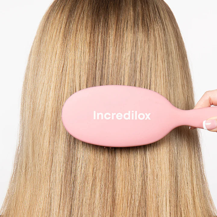 lady using a Incredilox Detangling Hair Brush