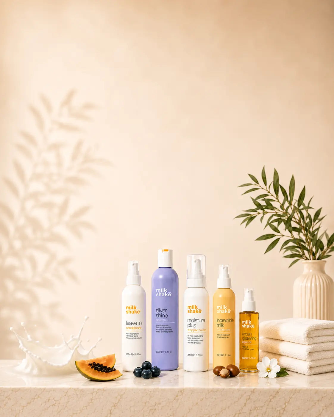 Set of milk_shake skincare products on a table with a decorative background