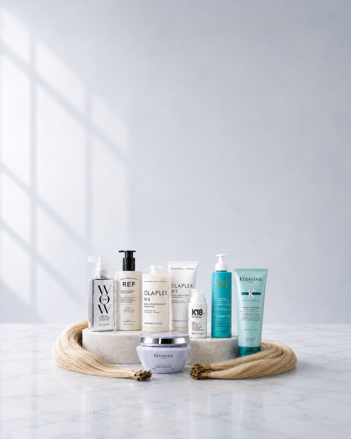 Mobile banner image for hair extension aftercare featuring Colour Wow, REF, Olaplex, K18, Moroccanoil and Kérastase products with blonde hair extensions