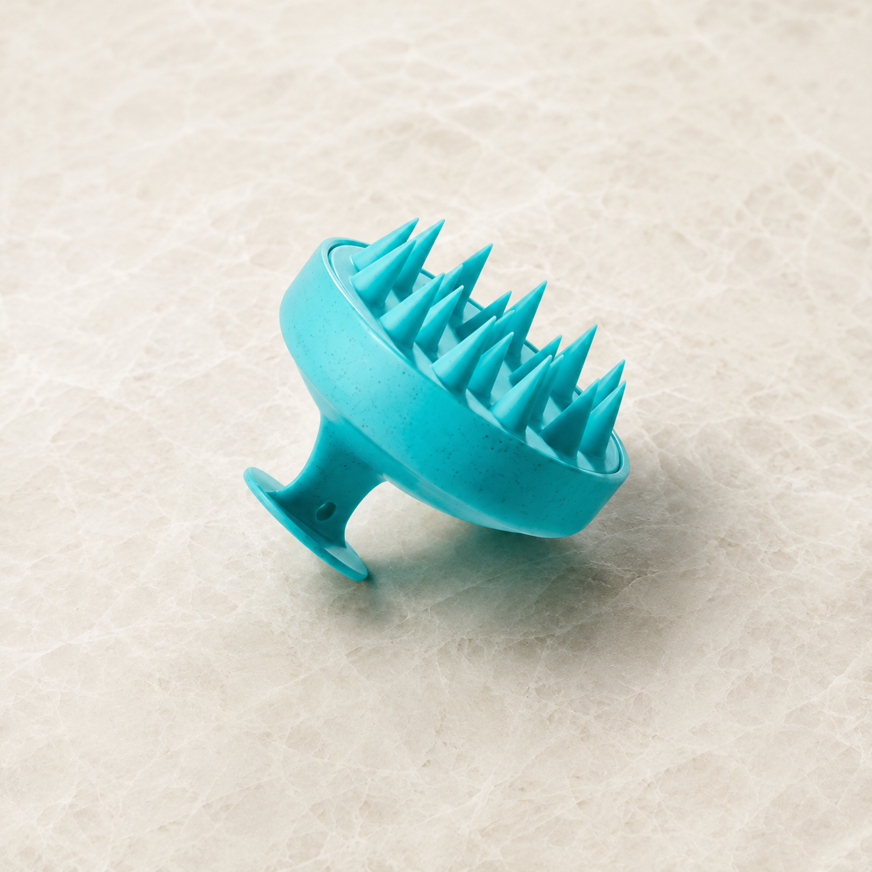 Moroccanoil scalp massage brush product photo for scalp care, exfoliation, cleansing support and relaxing scalp massage.